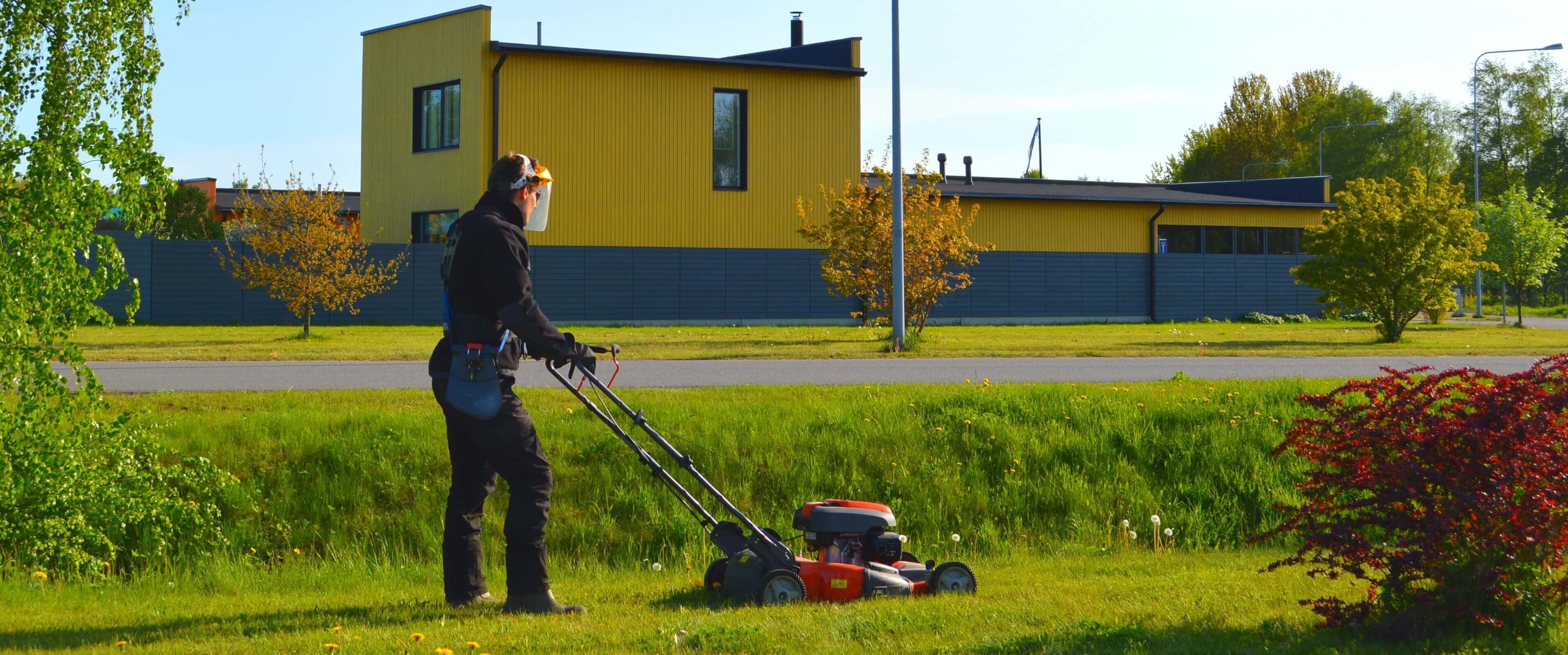Landscaping in the autumn season: maintenance of the territory, leaves cleaning and the last lawn mowing  before winter